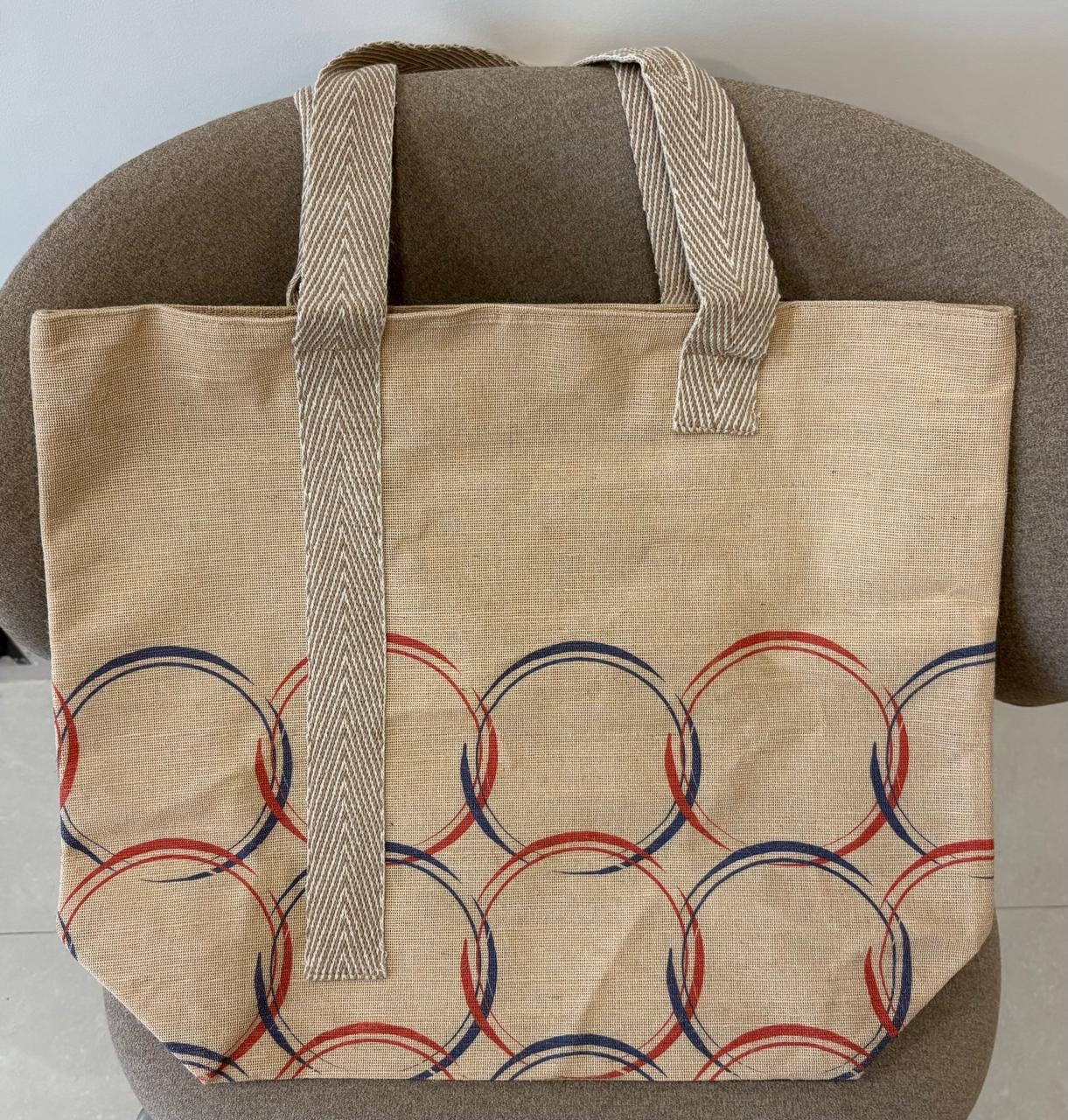 Veronica jute-cotton bag in an overlapping rust and navy ring print.